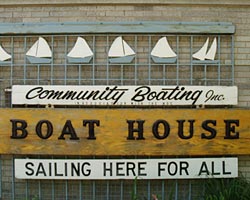 Sign saying: Community Boating Inc. Boat House, Sailing Here for All.