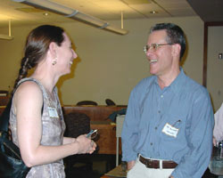 Speaker Bill Buchholz shares a laugh with member Joyce Dostale.